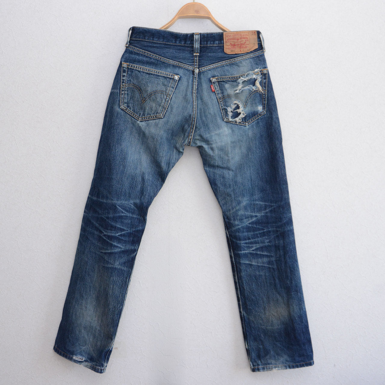 Levi's 501 button fly jeans, deep honeycomb fading behind knees, vintage distressed denim