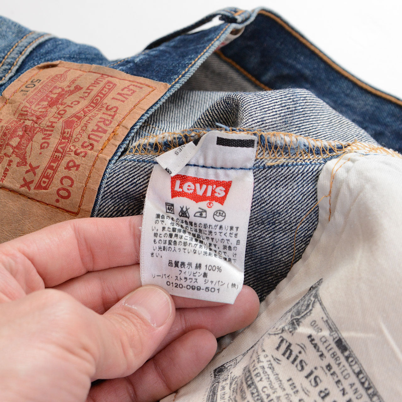 Levi's 501 denim, heavy overall fade, fraying at hem, surface abrasion, vintage condition