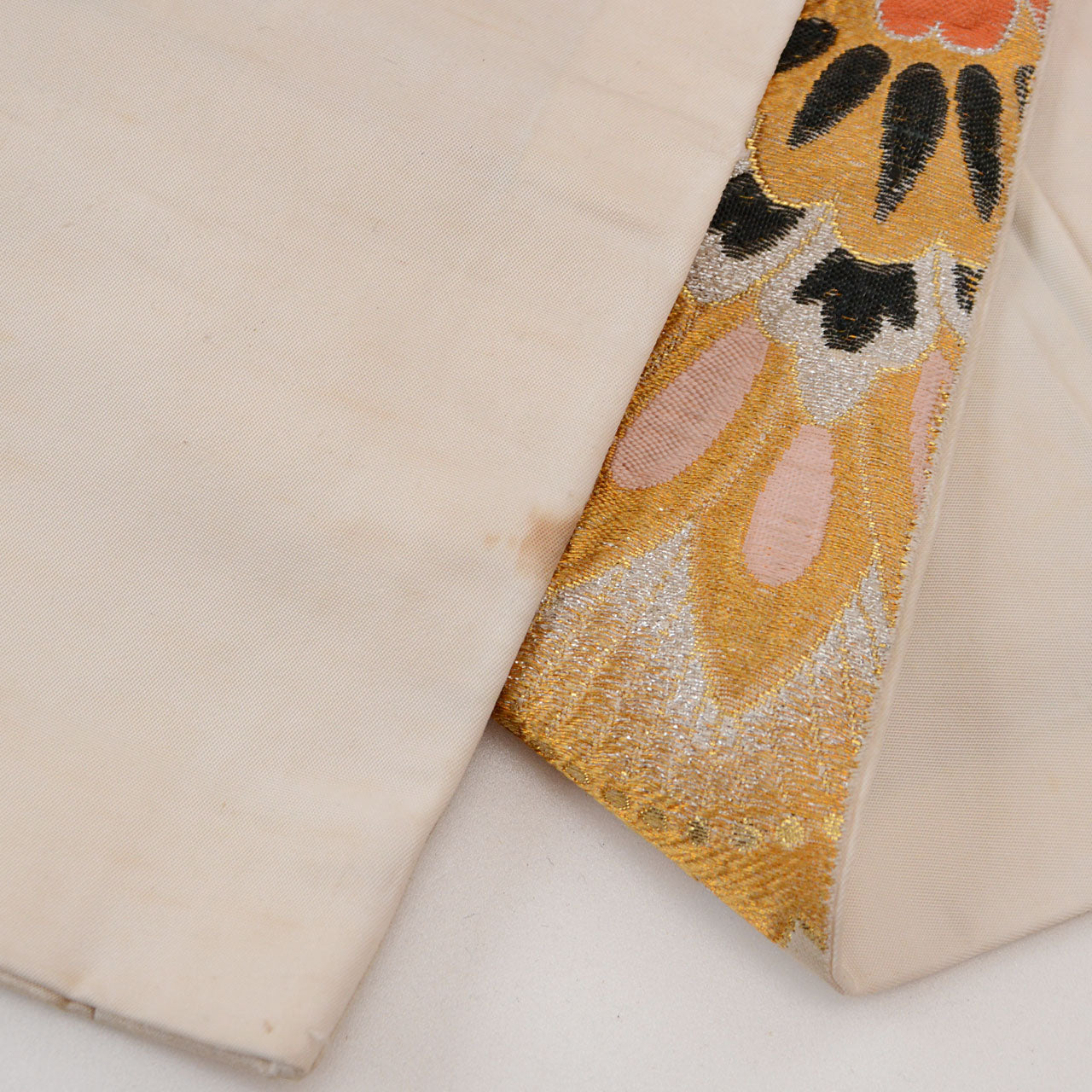 Traditional Japanese woven belt textile featuring floral patterns in gold and silver thread