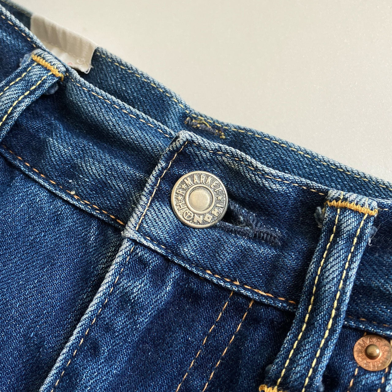 BLUE BLUE jeans with partially missing hip pocket stitching
