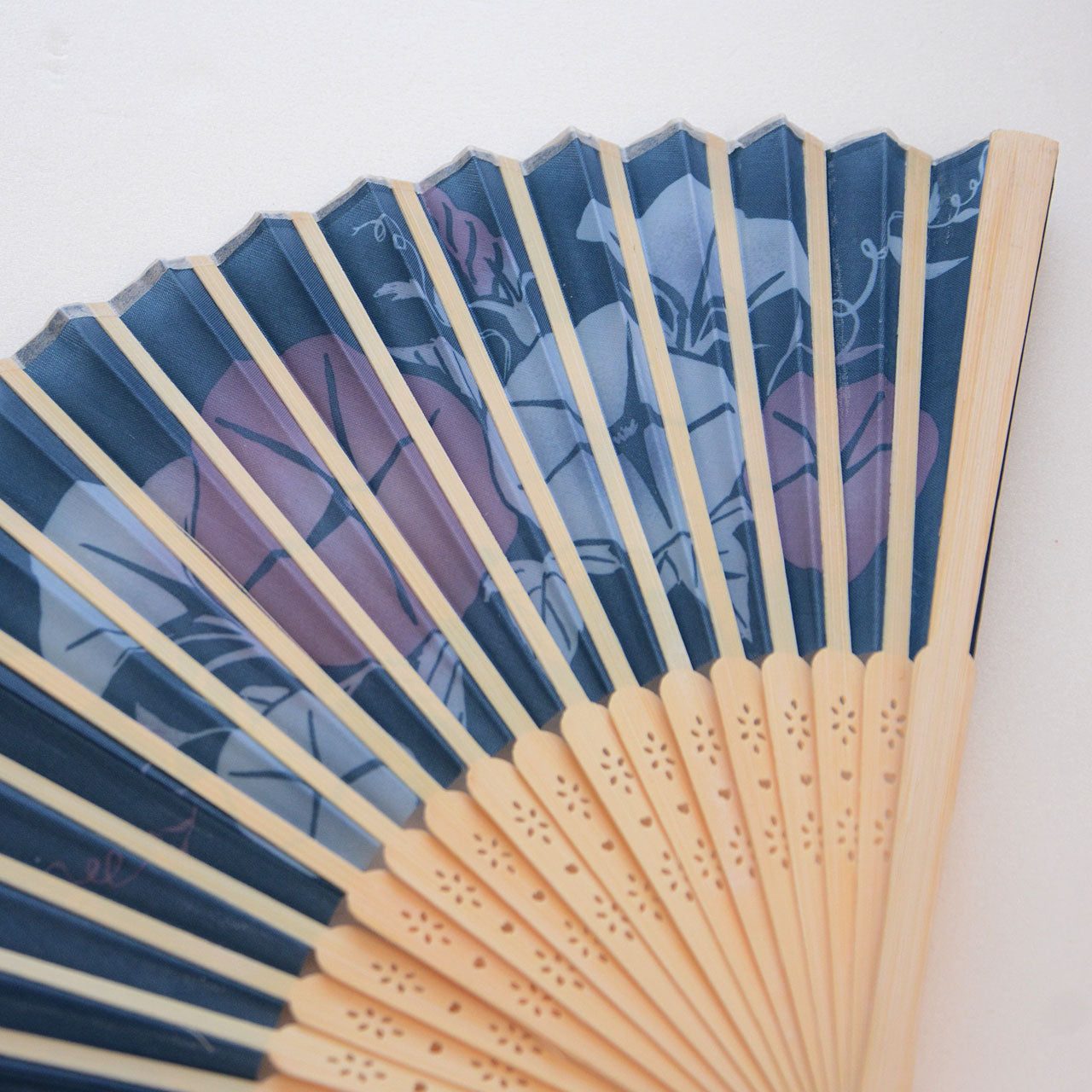 Artistic folding fan showcasing seasonal Japanese flowers