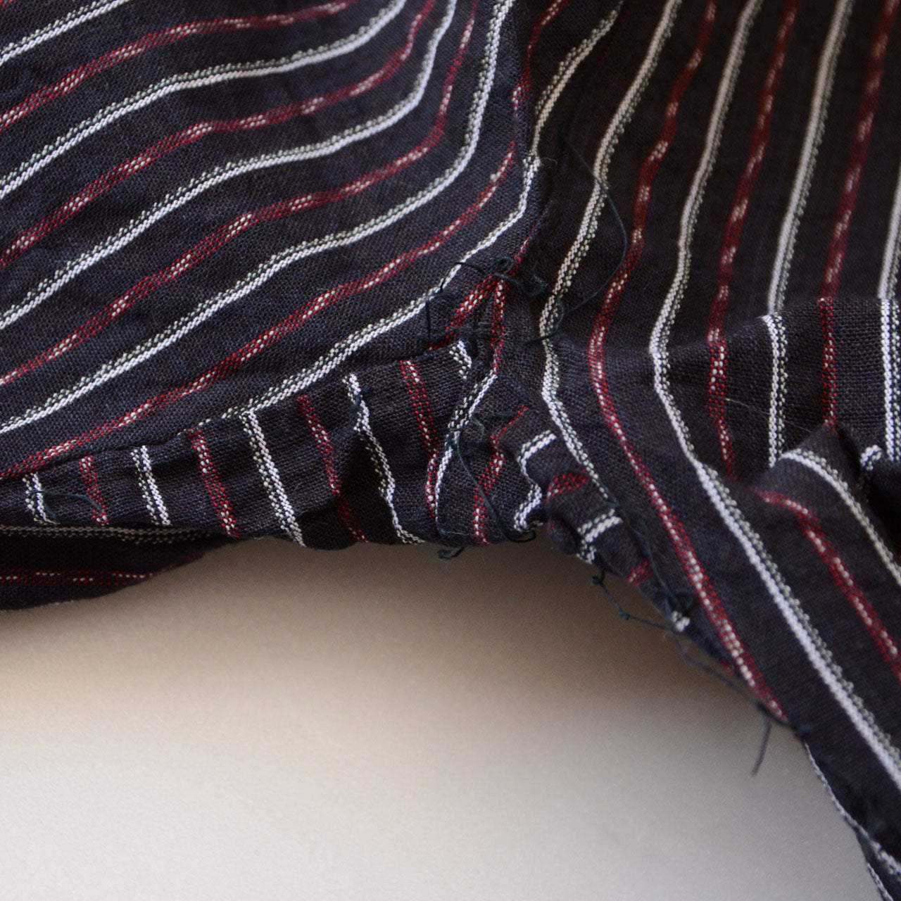 Close-up of the gusset at the crotch of vintage Japanese monpe pants made from striped cotton fabric. The gusset design adds flexibility and comfort, a distinctive detail commonly seen in traditional workwear.