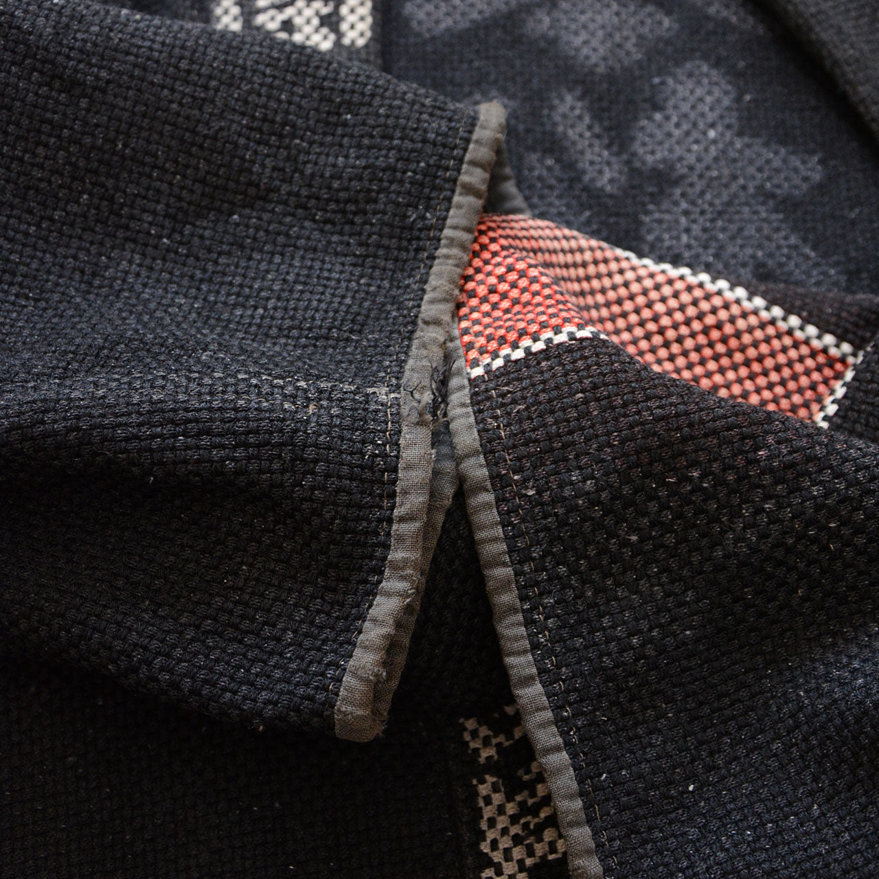 Back view of a vintage firefighter hanten showing bold typography