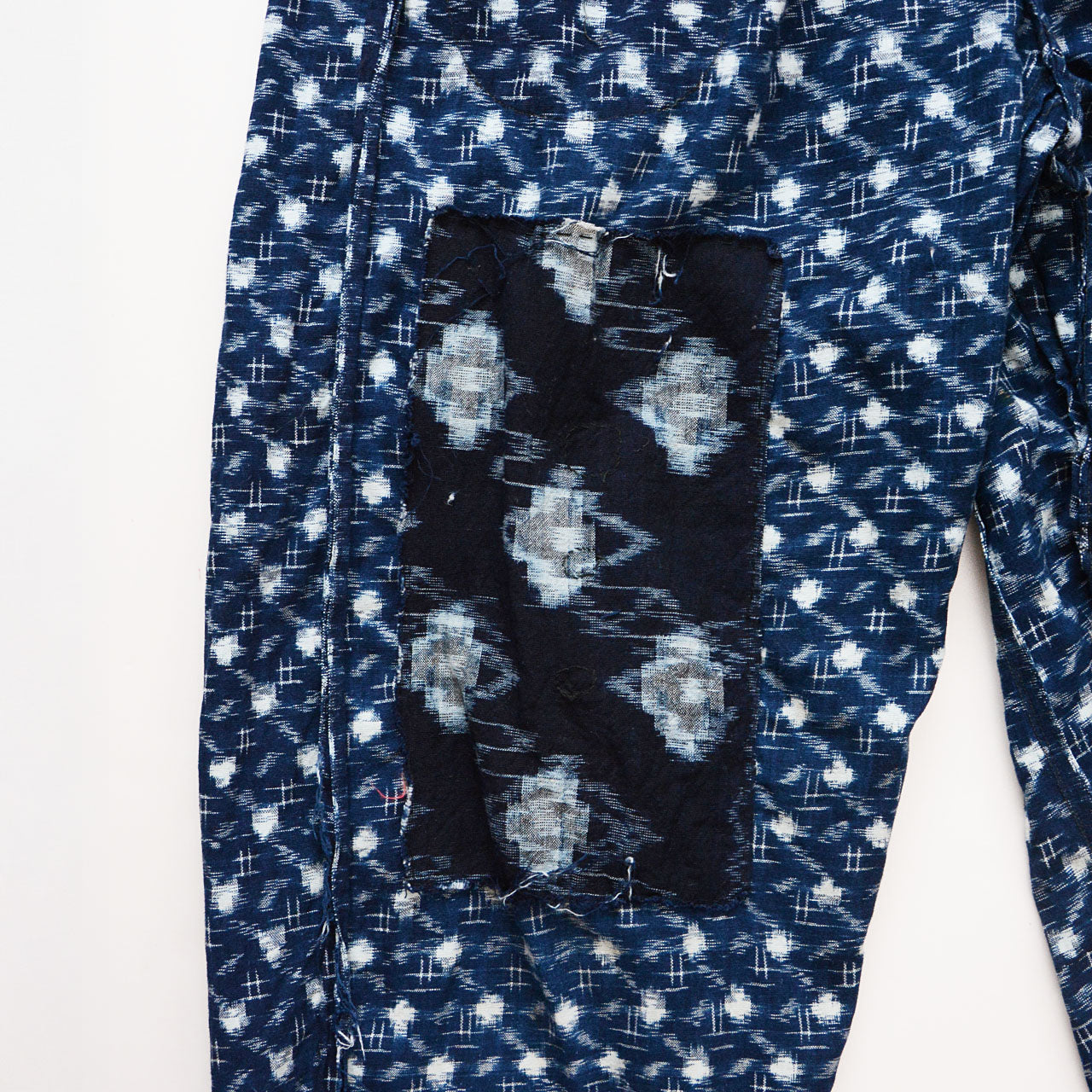 Faded indigo monpe trousers styled with modern minimalist outfits
