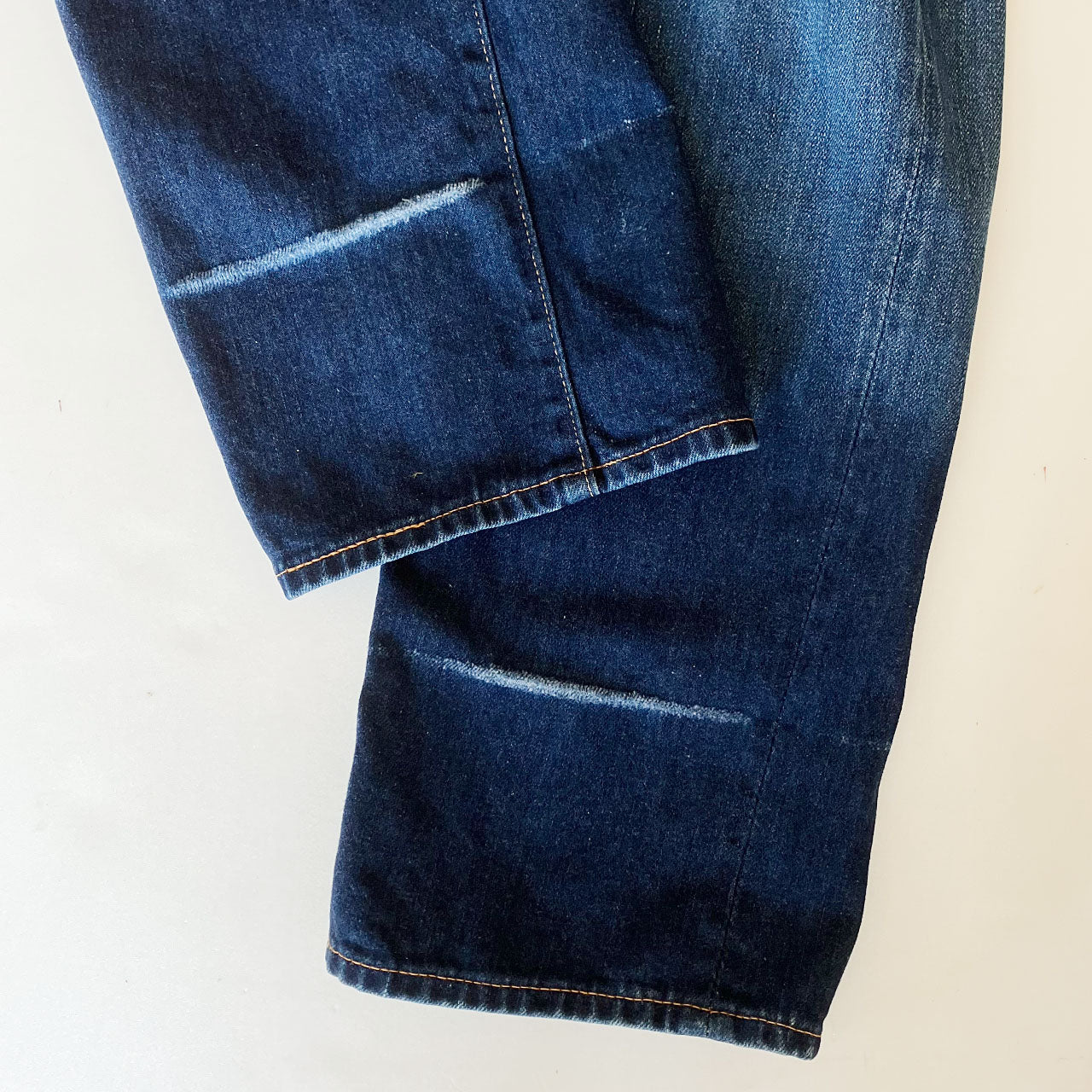 BLUE BLUE denim showcasing unique whisker and thigh fading