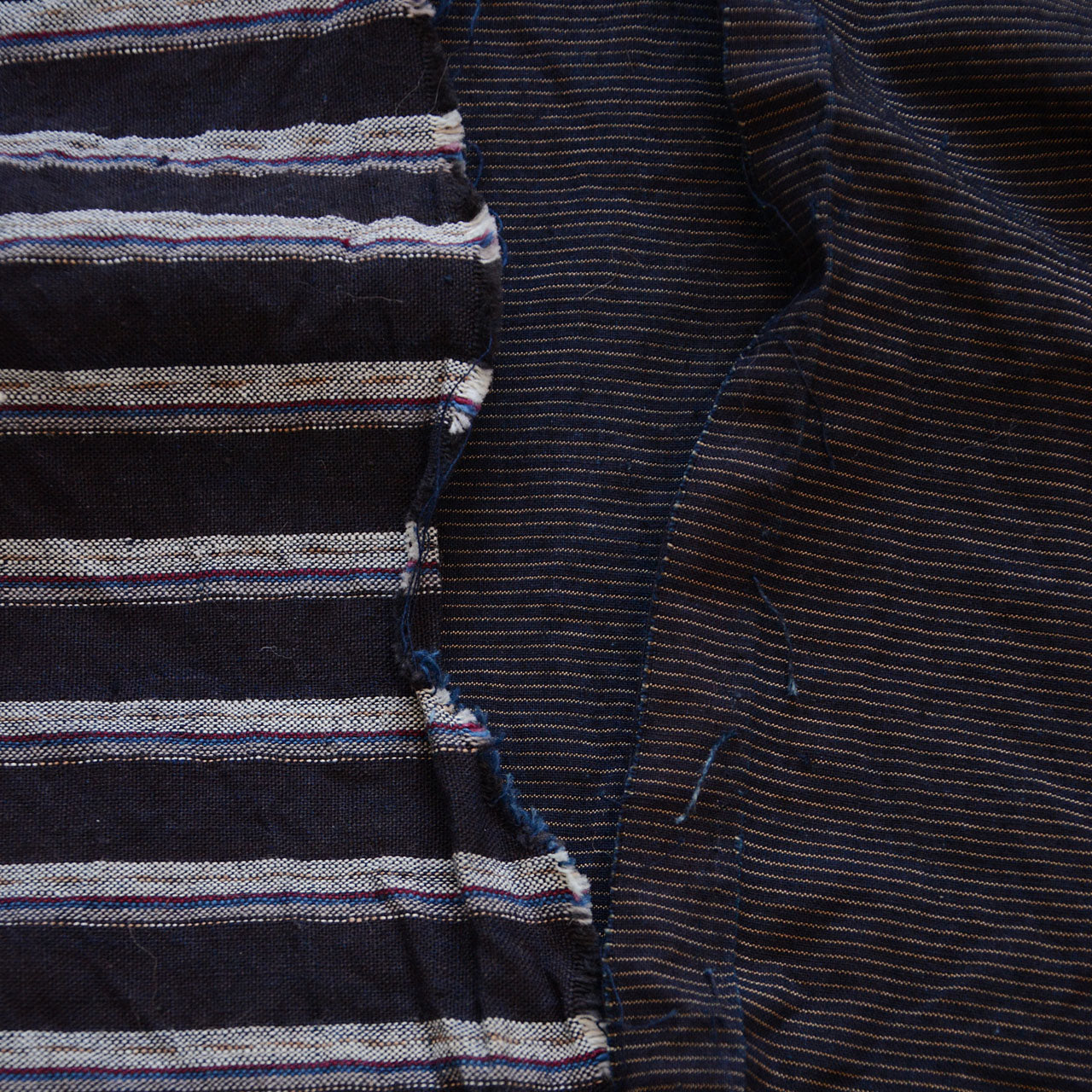 Antique indigo textile scarf with frayed edges and uneven seams