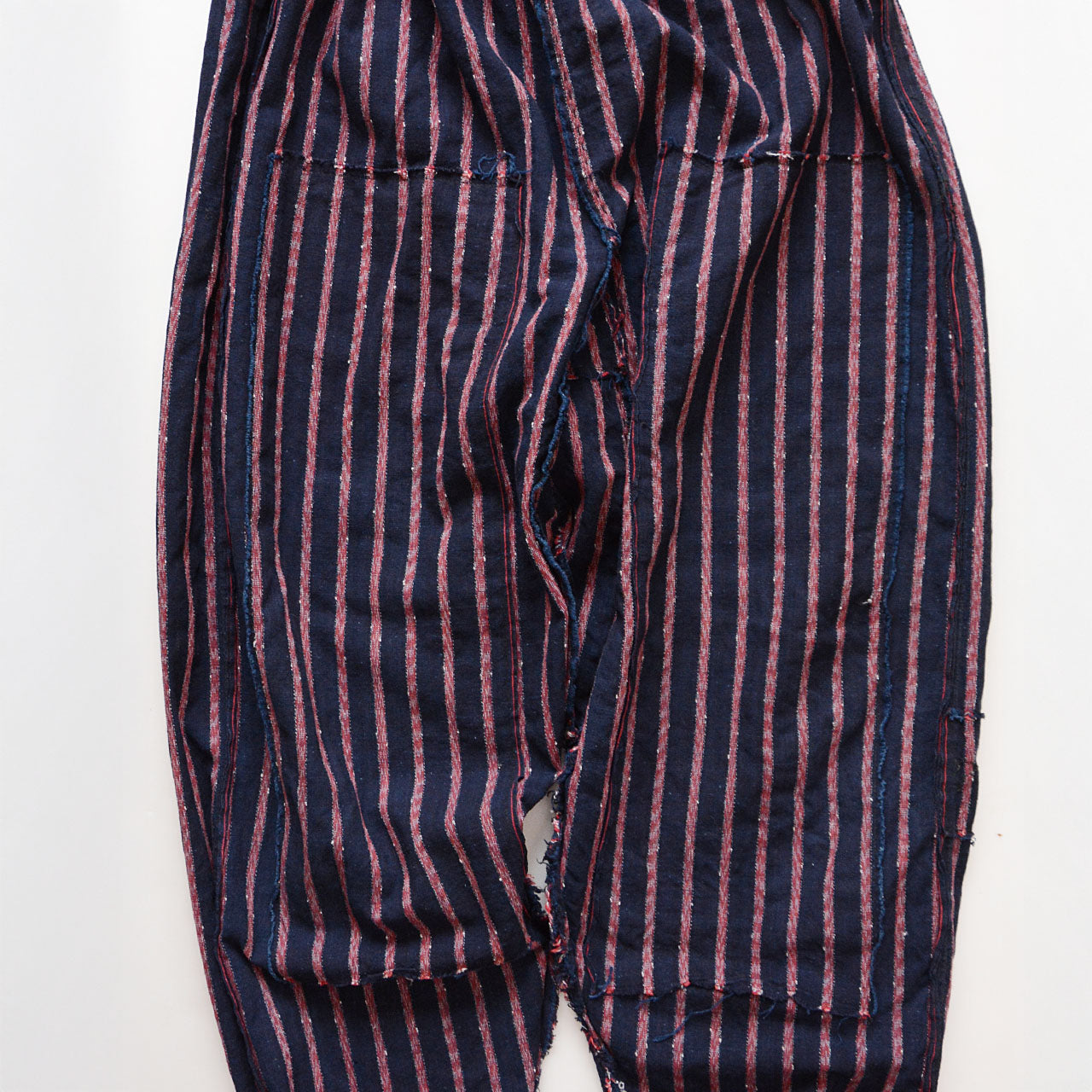 Old Japanese farmers’ work pants with repair patches and traditional kohaze fasteners