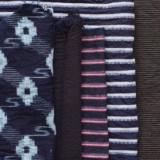 Assorted vintage Japanese fabric scraps including indigo kasuri, striped, and solid cotton pieces