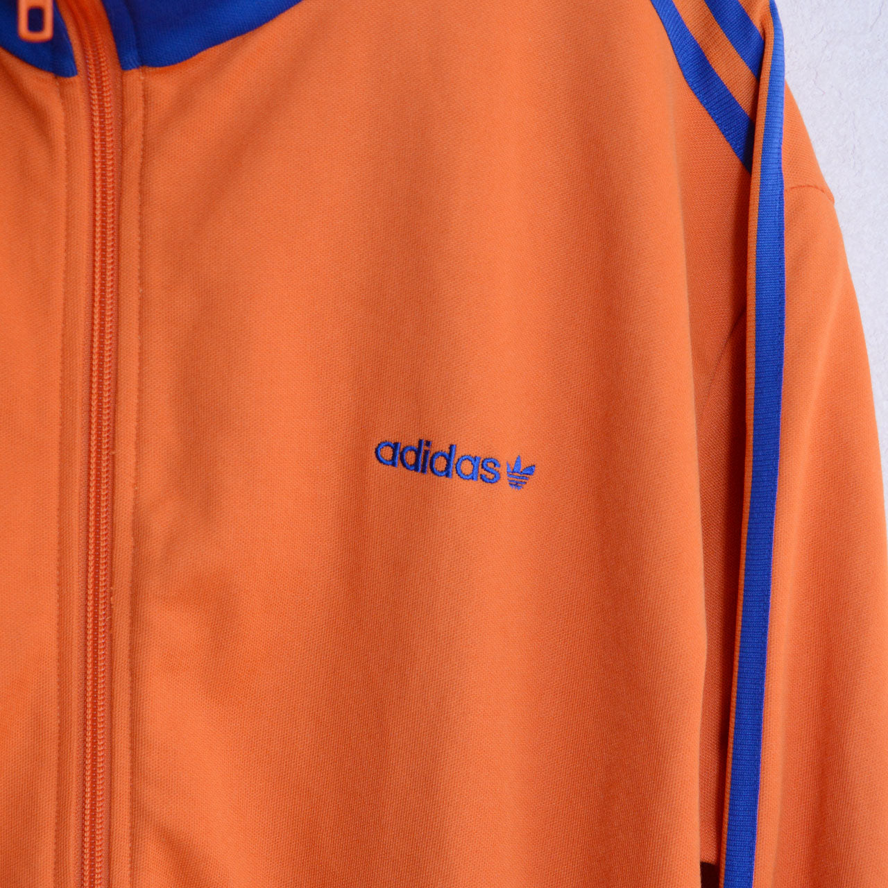 adidas track jacket, orange colorway, royal blue stripes and ribbing, trefoil logo
