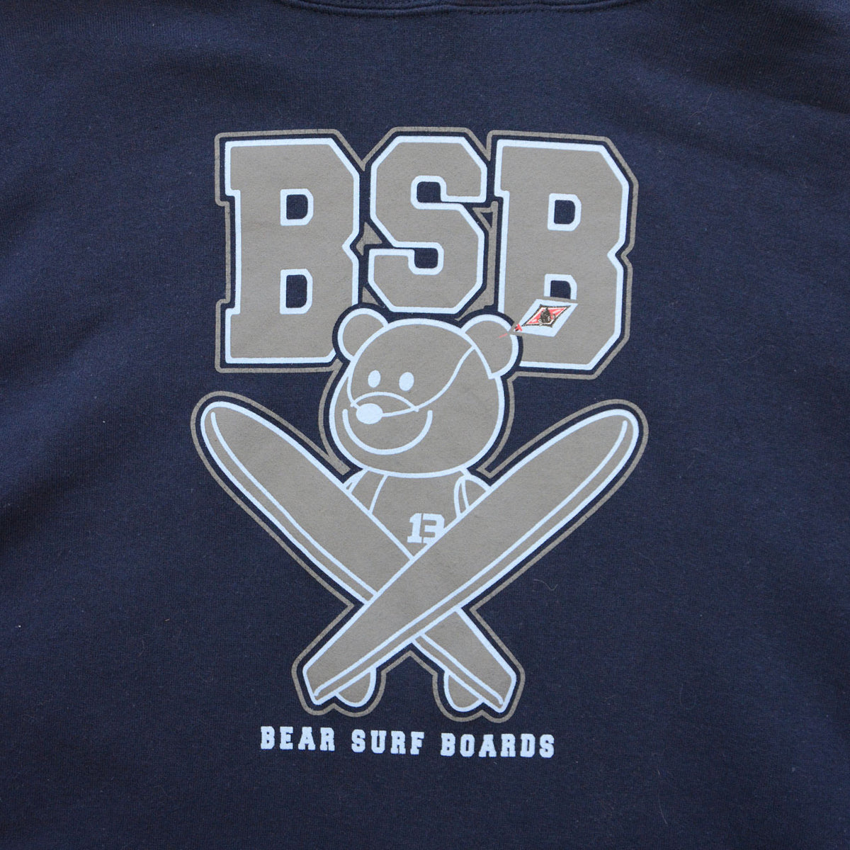 BSB bear and crossed surfboards graphic on navy BEAR SURFBOARDS hoodie