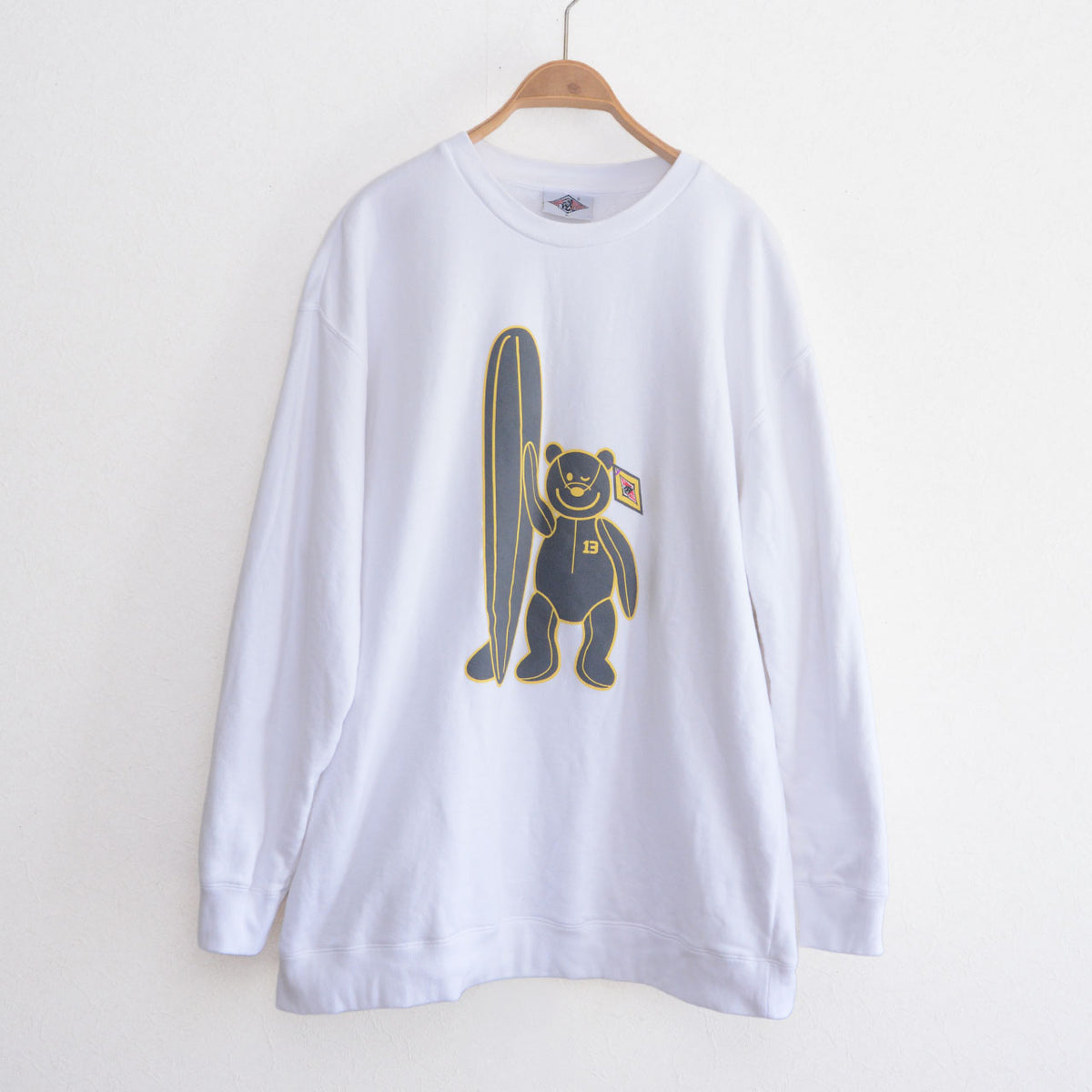 White oversized BEAR SURFBOARDS 3L sweatshirt with bear and surfboard graphic