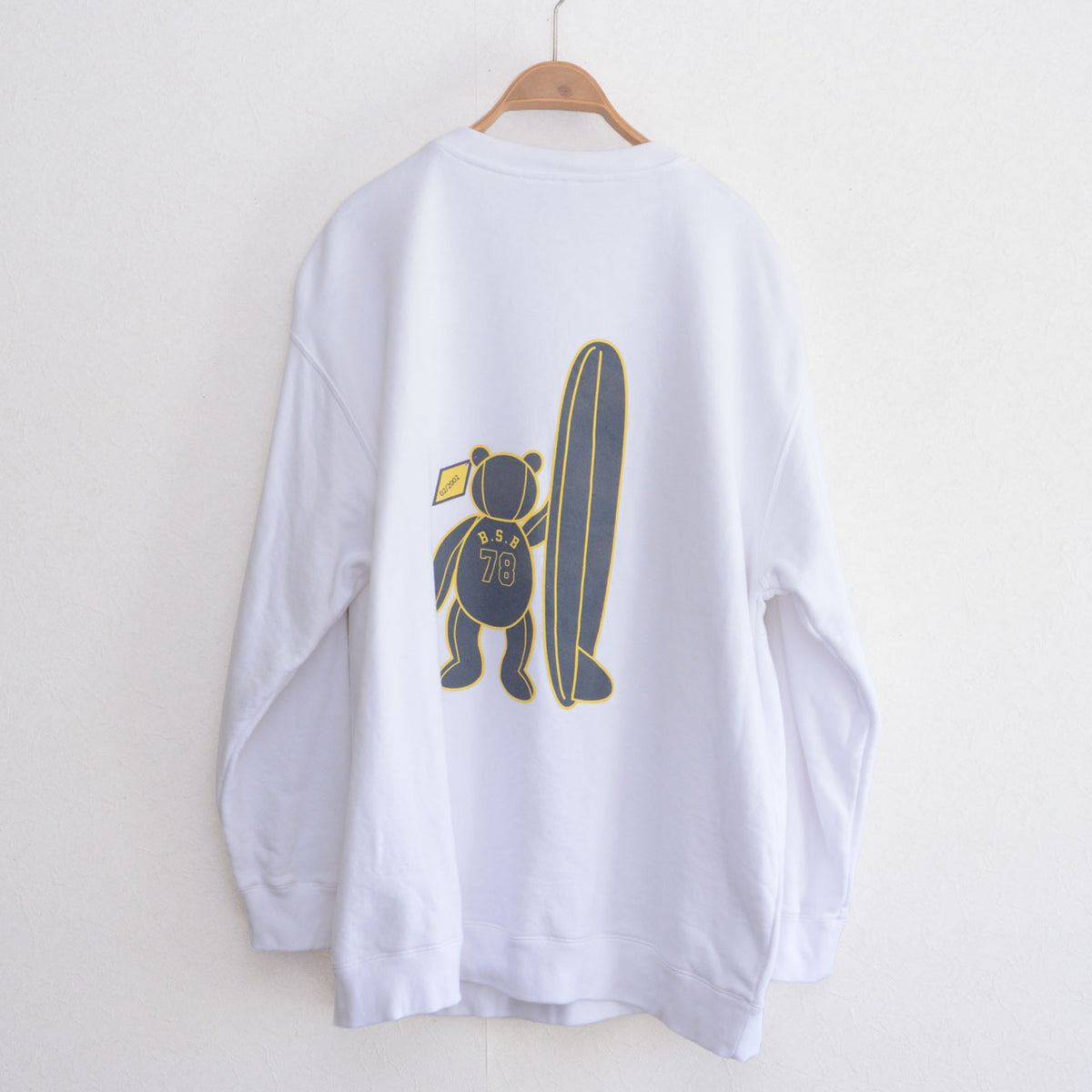 Back of white BEAR SURFBOARDS sweatshirt with bear and surfboard graphic