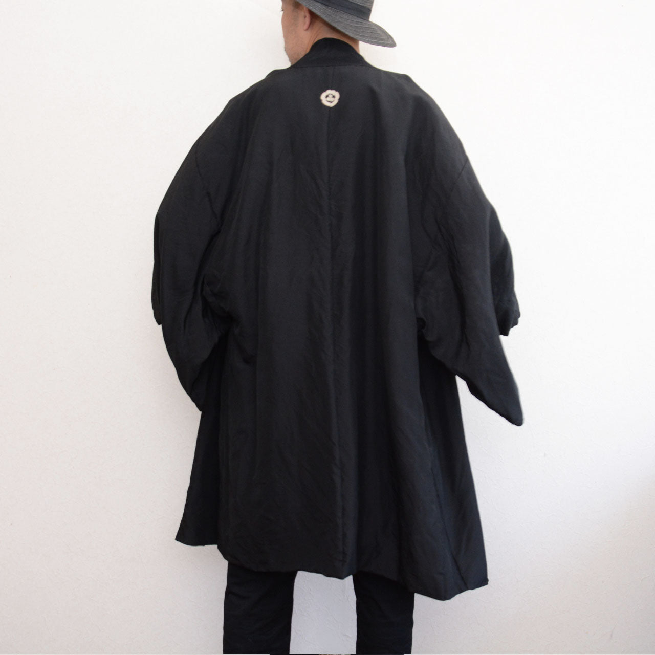 Vintage black silk haori with family crests and woven landscape lining