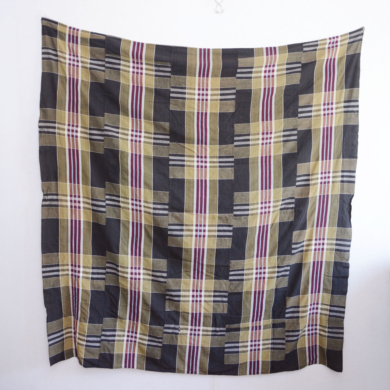 Vintage Japanese boro futon-gawa fabric, plaid cotton in black, khaki, burgundy and white, hung flat showing reverse side and overall drape, Showa era