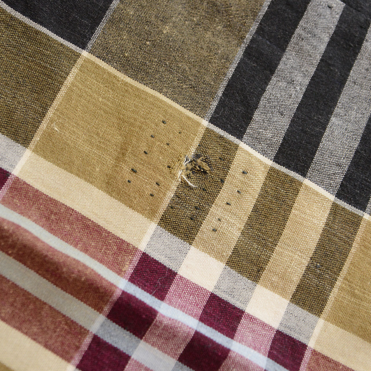 Vintage Japanese boro futon-gawa fabric, plaid cotton in black, khaki, burgundy and white, large khaki patch repair with hand-stitched running stitch border, Showa era