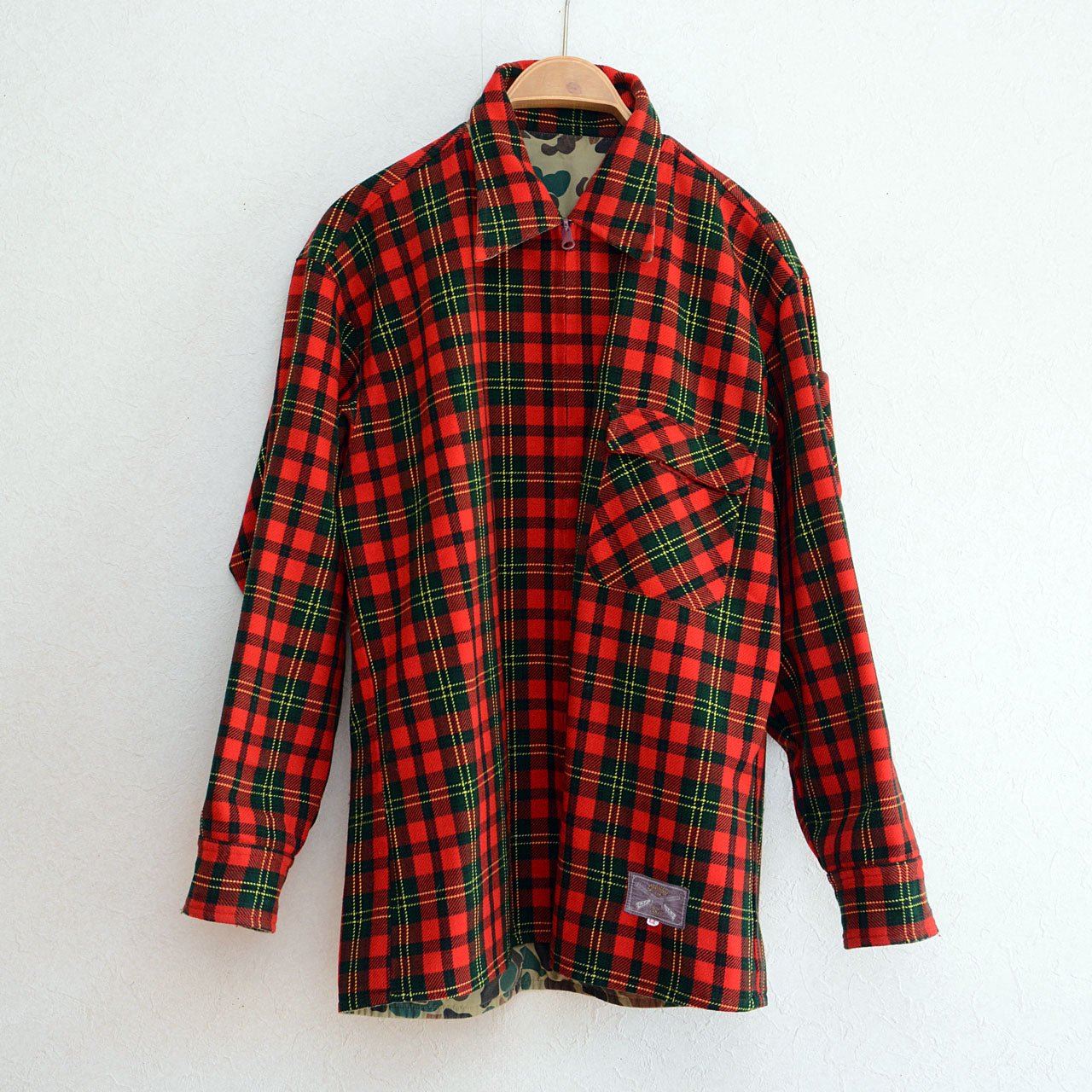 Vintage hunting jacket with red check outer and camo inner