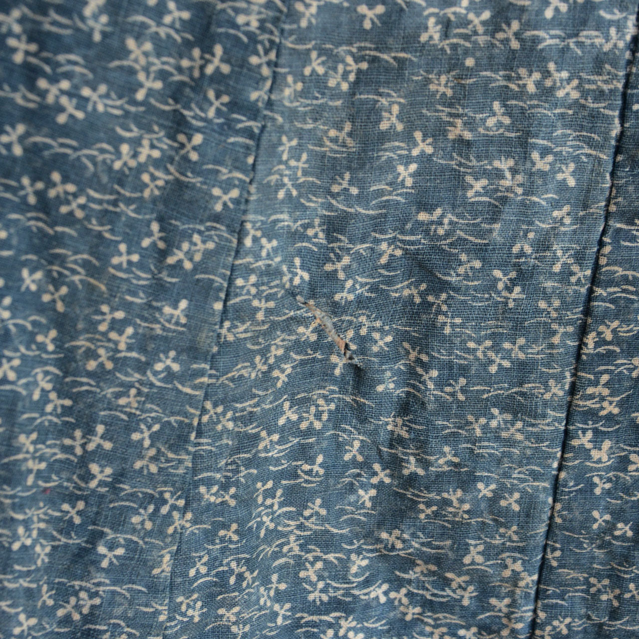 A historical Japanese indigo-dyed cotton rain garment.
