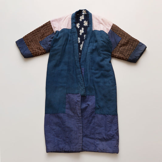 Back side of vintage Japanese hanten padded jacket, flat lay, showing indigo kasuri outer fabric