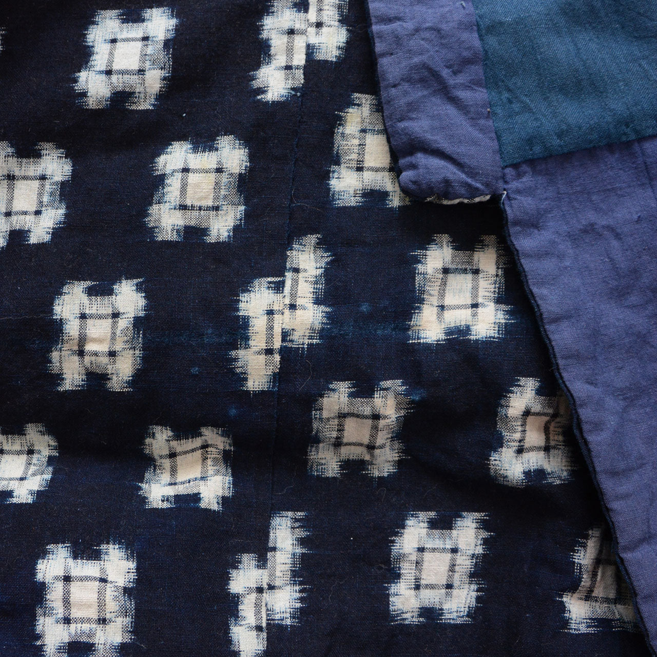 Close-up of indigo kasuri outer fabric and lining border, vintage hanten padded jacket