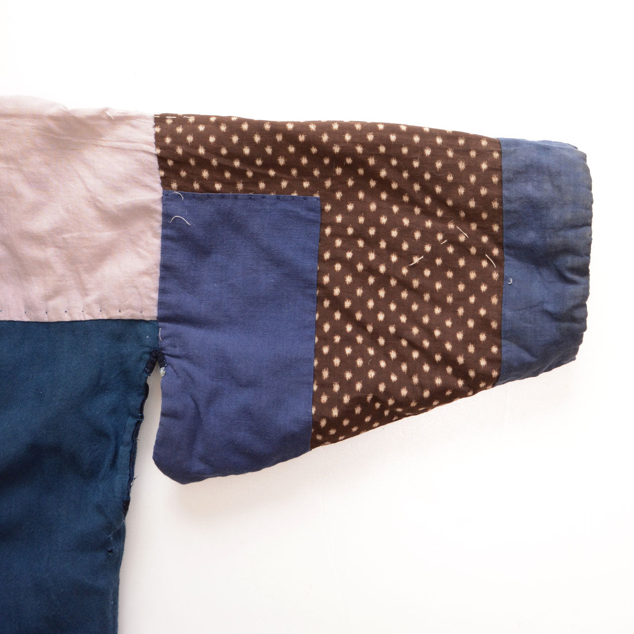 Close-up of crazy pattern lining sleeve — pale pink, navy, and brown yukko kasuri fabrics pieced together