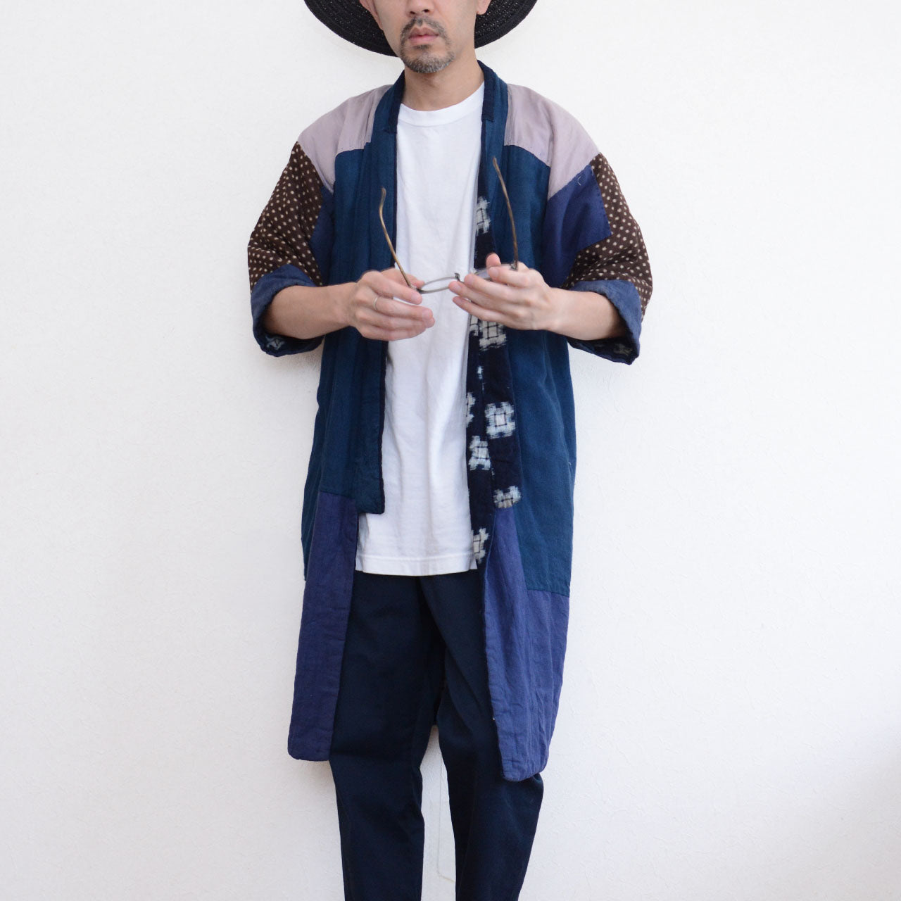 Model wearing vintage Japanese hanten padded jacket open, front view, showing indigo kasuri and crazy pattern lining contrast