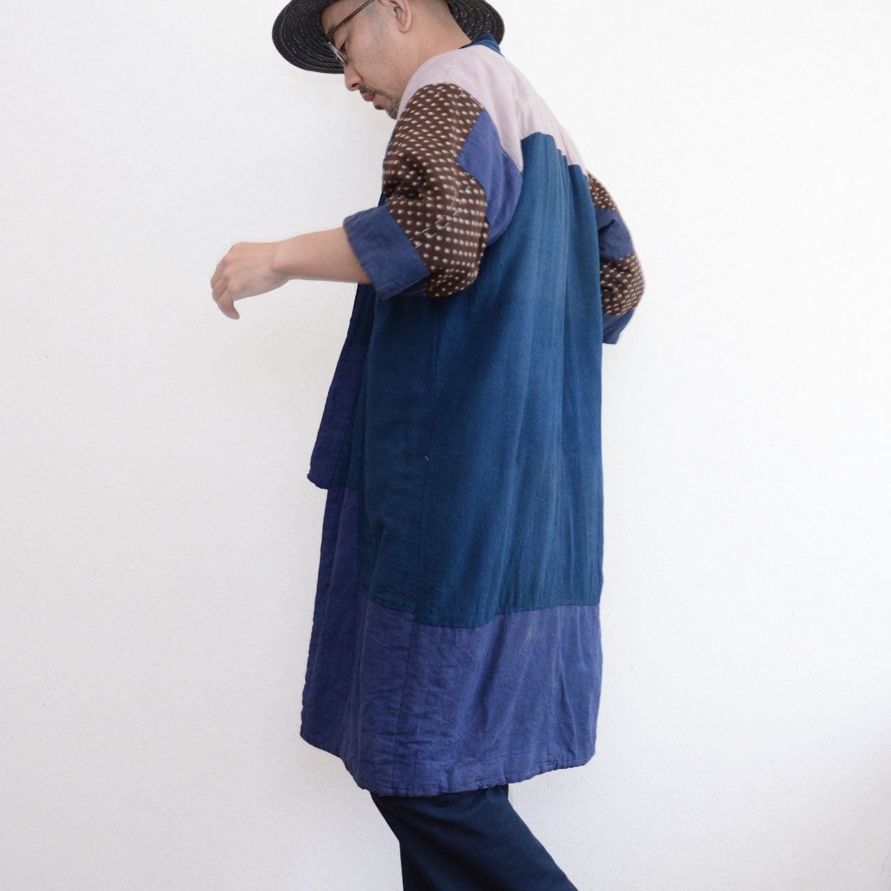 Model wearing vintage Japanese hanten padded jacket, side rear view, showing drape and hem detail