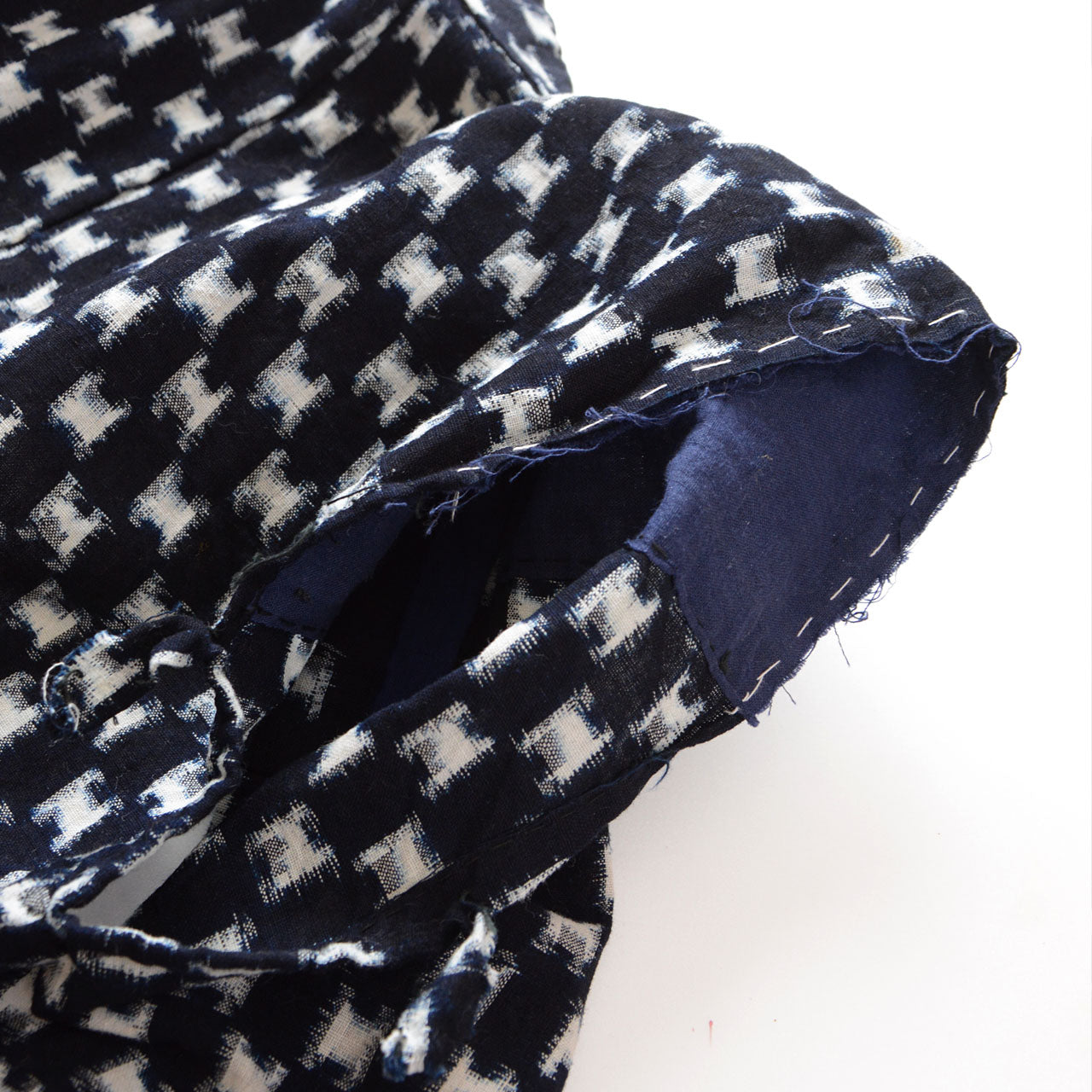 Armhole opening of sleeveless haori vest, raw edge detail where sleeves were removed