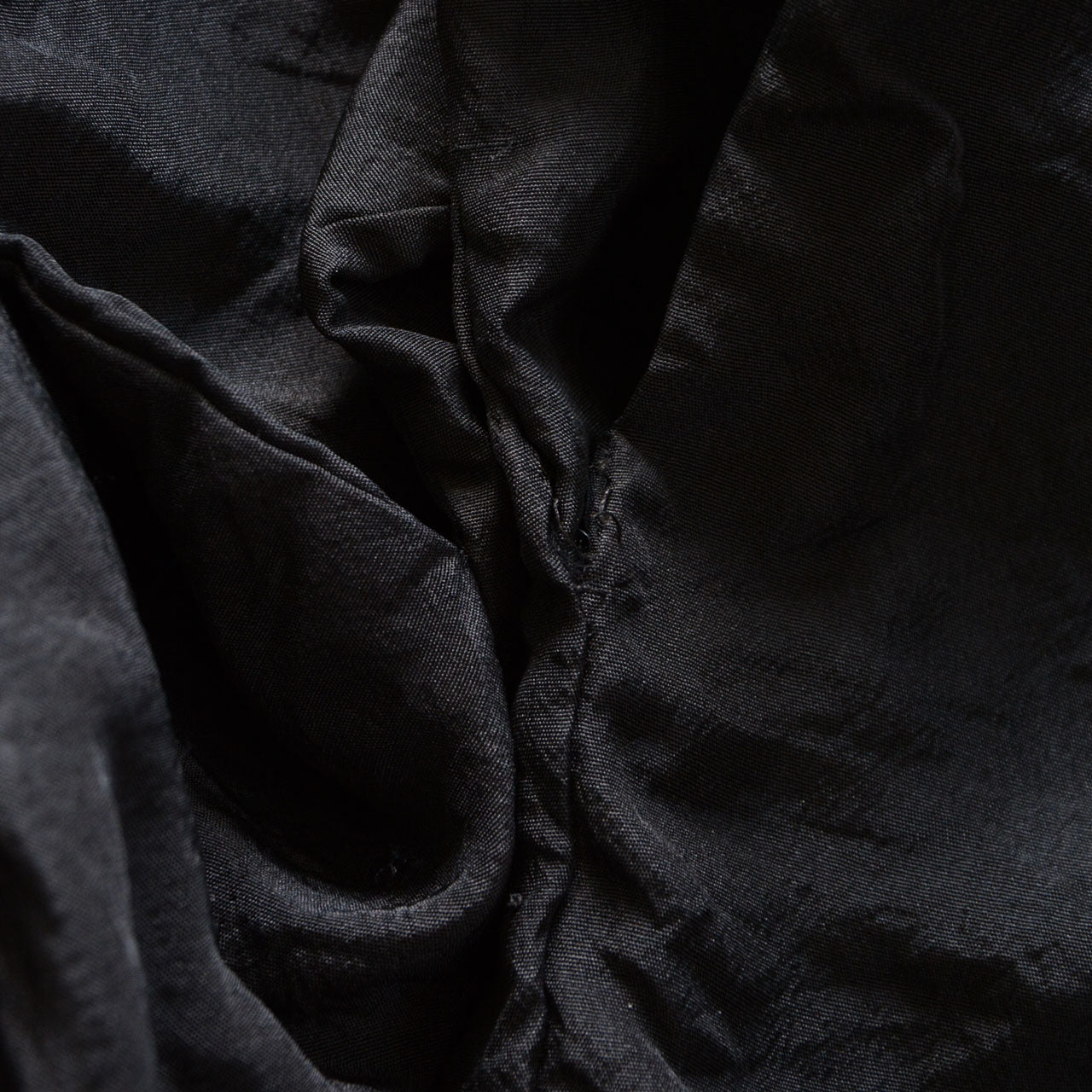 Close-up of haori sleeve cuff showing fraying at the edge, condition detail, Japan vintage black haori