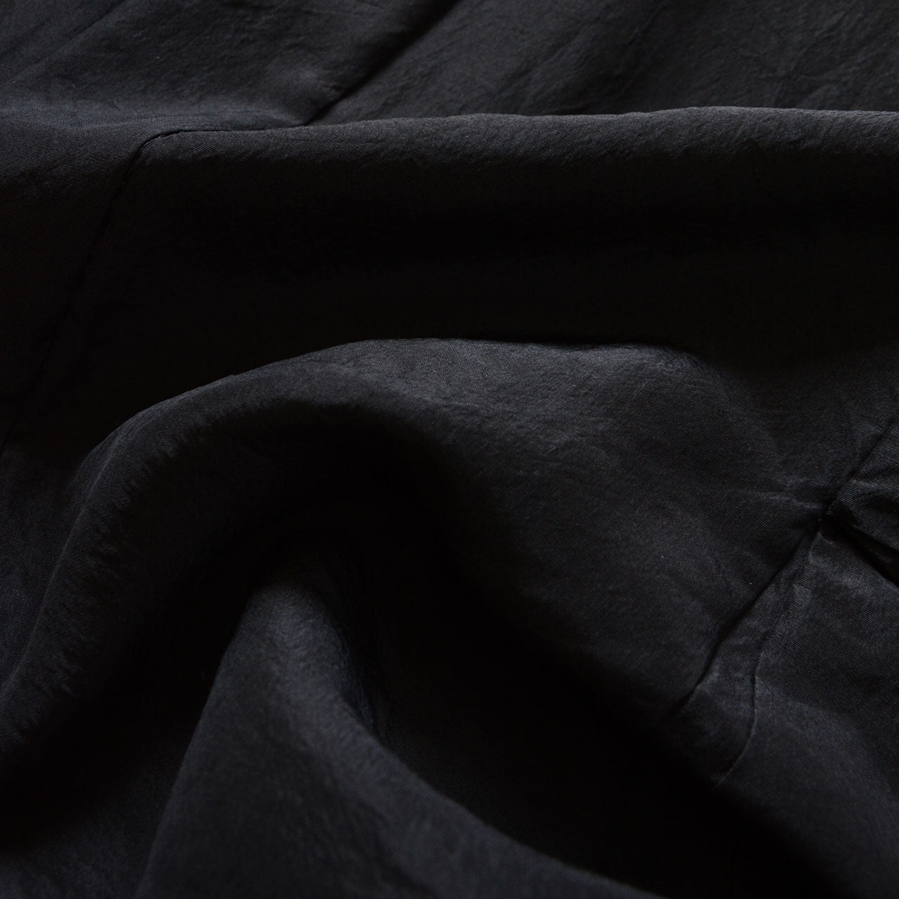 Close-up of black haori fabric drape showing soft texture and subtle sheen of mixed-weave textile, Japan vintage