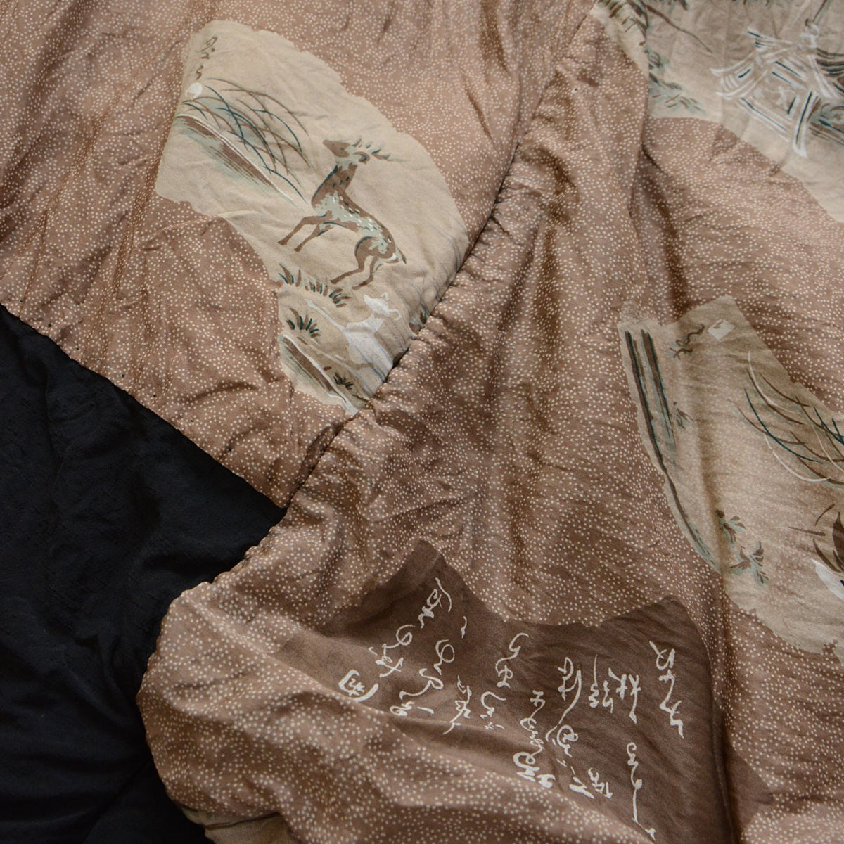 Brown and beige lining with a deer, grasses, Japanese calligraphy, and fine white dots on a vintage men's haori jacket