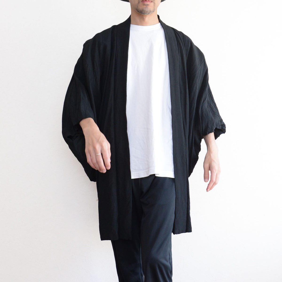 Men's black Japanese vintage haori jacket with a long straight silhouette and roomy sleeves, paired with a white T-shirt and black trousers