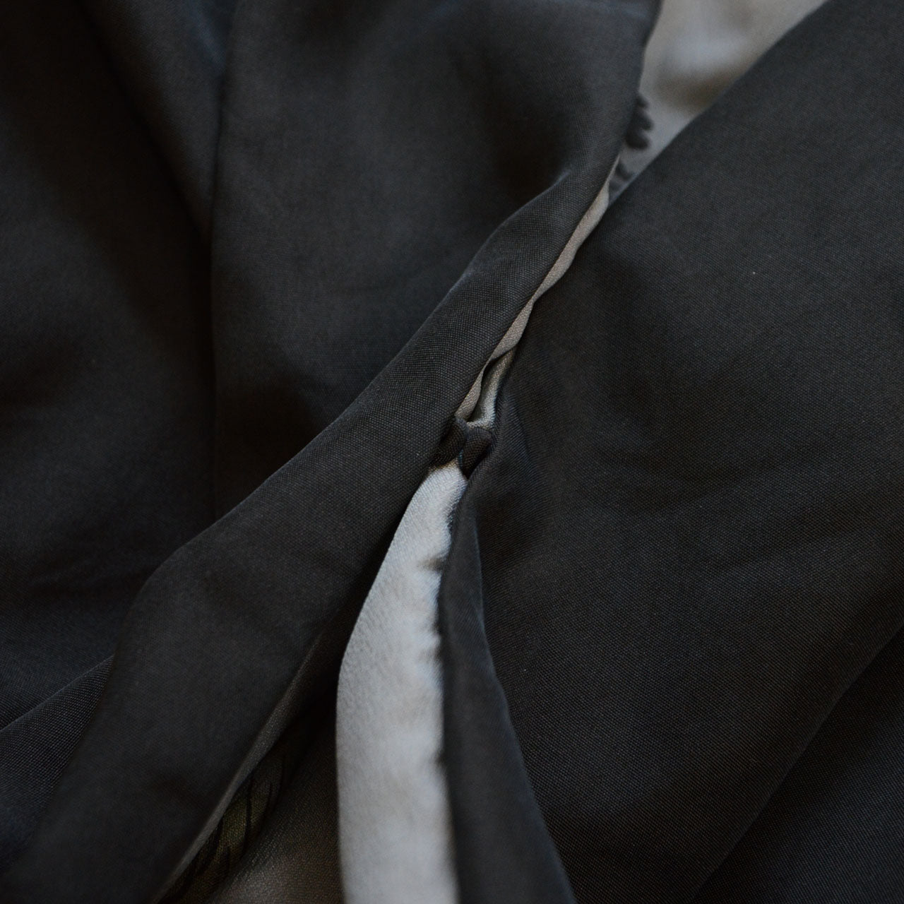 Close-up of chi loops (haori-himo attachment points) on black silk itsutsumon haori
