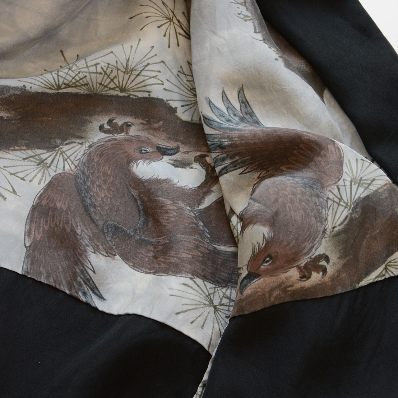 Close-up of haori lining, eagle perched on pine branch, Japanese ink wash painting style, silver-grey silk