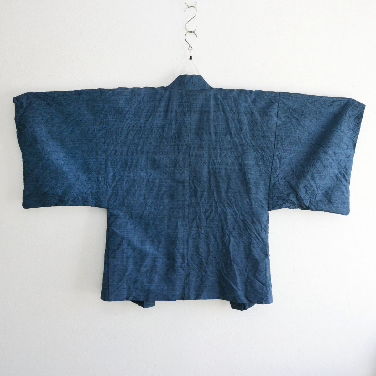 Blue outer fabric and center seam of a men’s Japanese vintage haori jacket