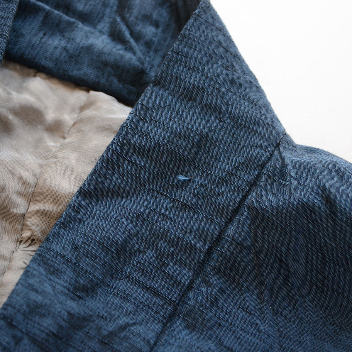 Loose threads on the blue collar fabric of a Japanese vintage haori jacket