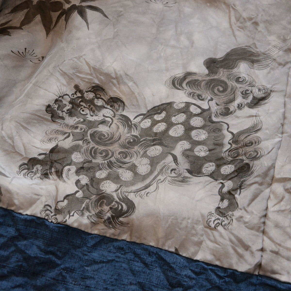 Karajishi lion with spotted body, curling tail and bamboo leaf motifs on vintage haori lining