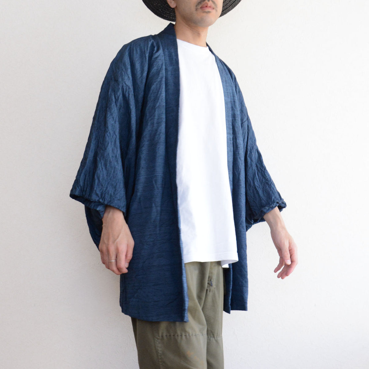 Men’s blue vintage haori jacket with wide sleeves, a white T-shirt and olive trousers