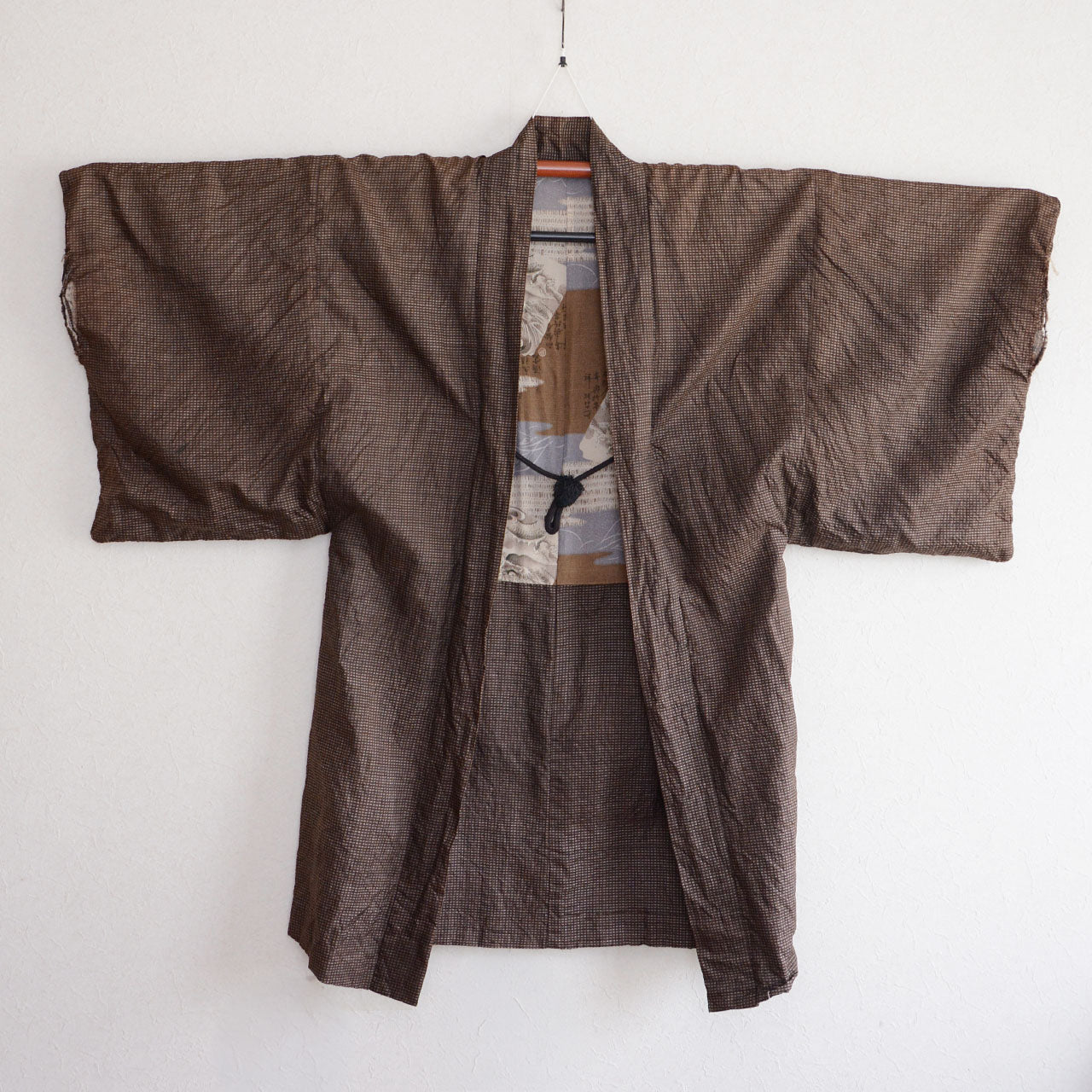 Men's Japanese vintage haori jacket, brown silk komon weave, open front with haori-himo cord, dragon and wave lining partially visible, Showa era