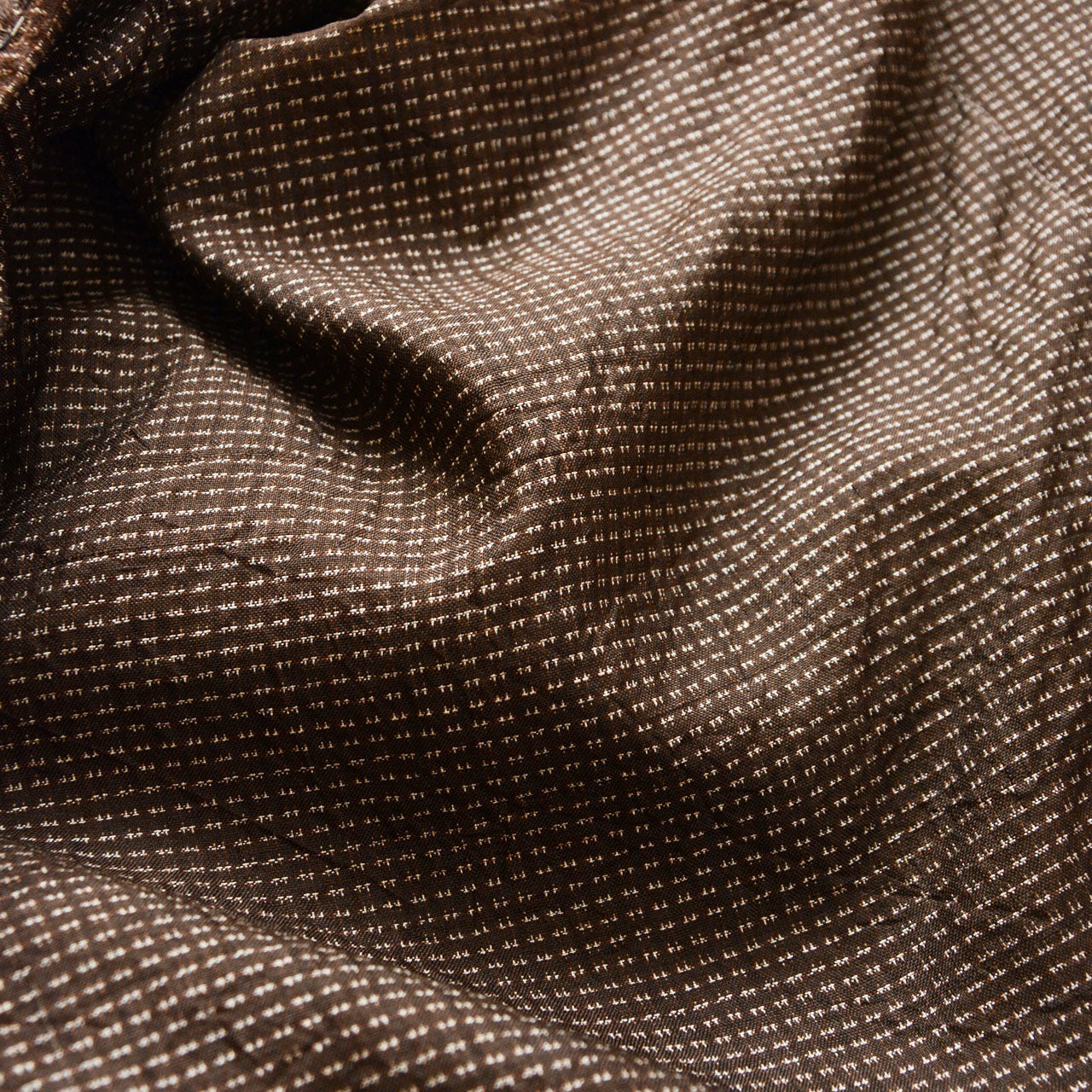 Close-up of brown silk komon weave with ivory dot pattern, Japanese vintage haori jacket exterior fabric detail