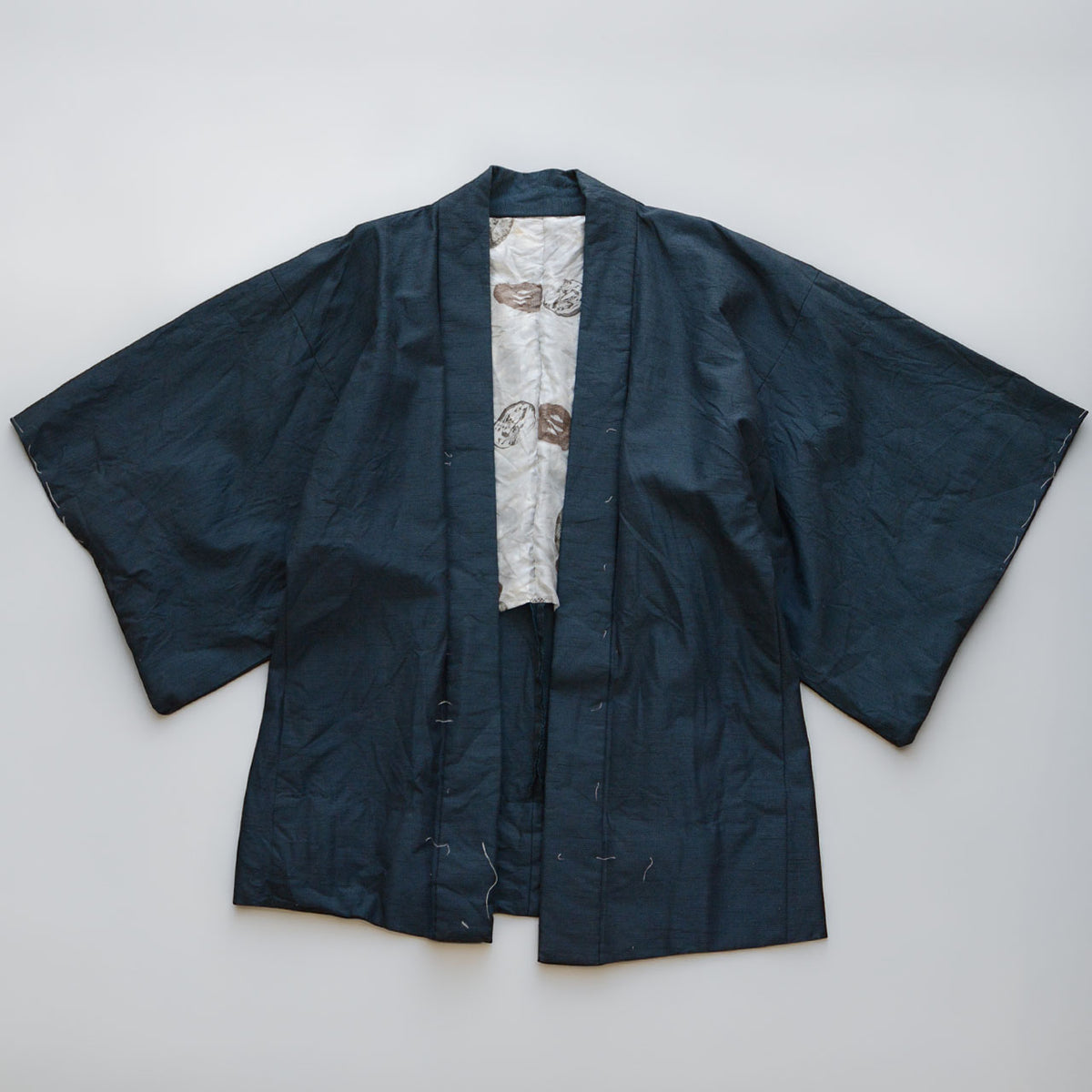 1970s–1980s Japanese vintage men's haori jacket in deep blue-green with subtle texture and a light-colored patterned lining.