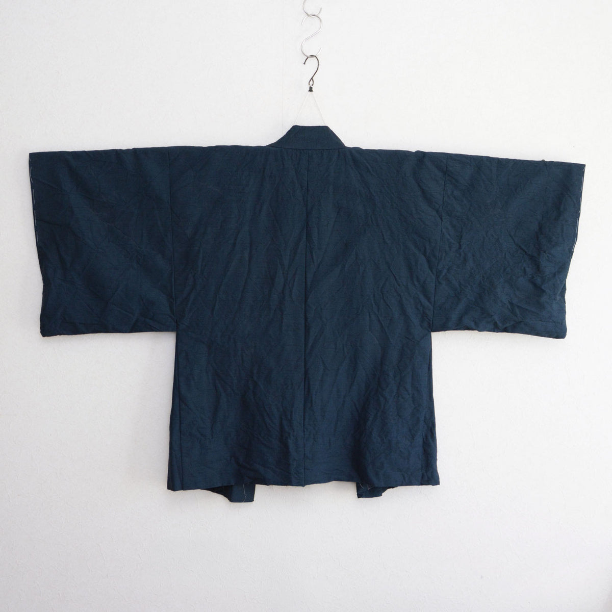 Deep blue-green Japanese vintage haori with subtle fabric texture, wide sleeves and a center seam.