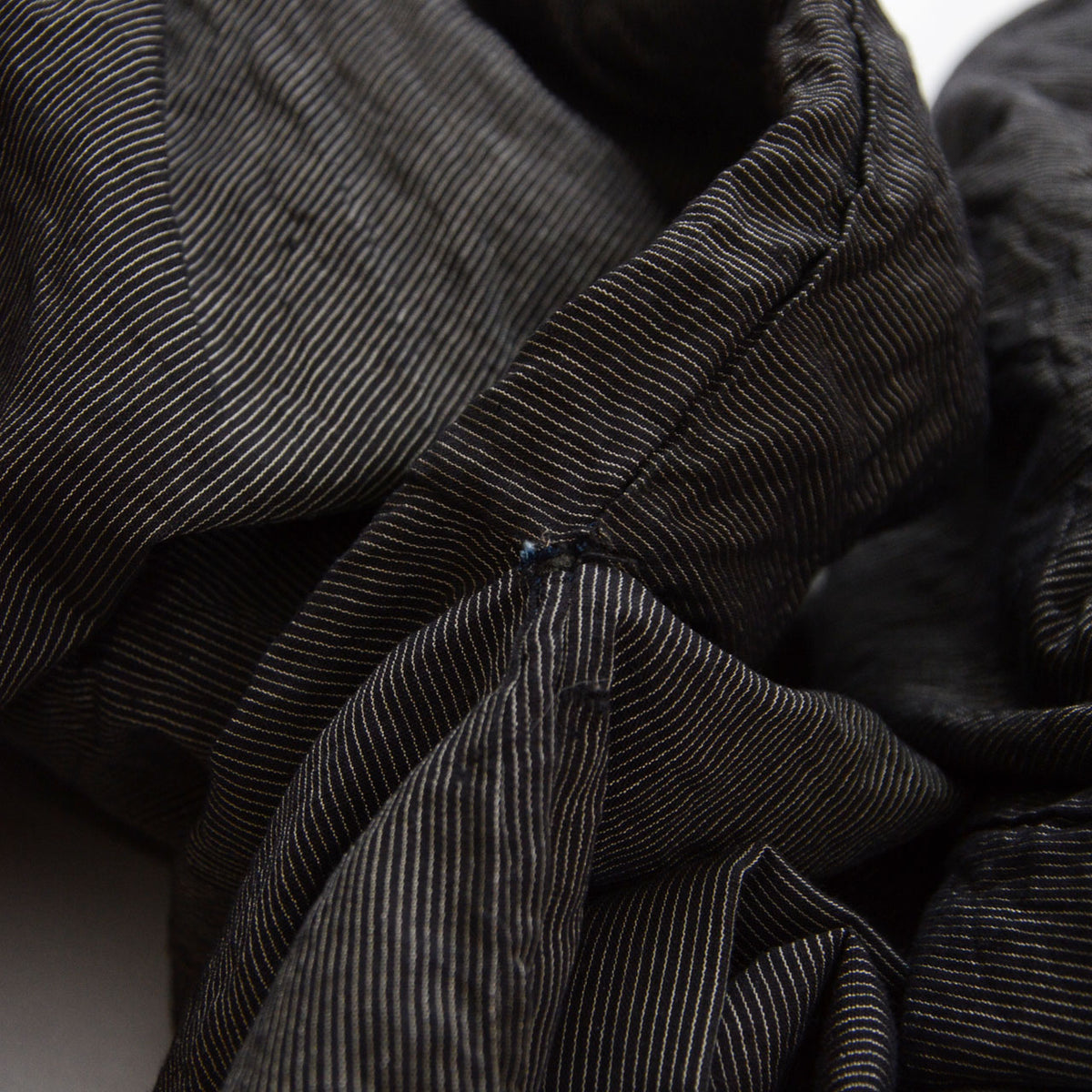 Loose stitching and an opening at the underarm seam of a vintage haori