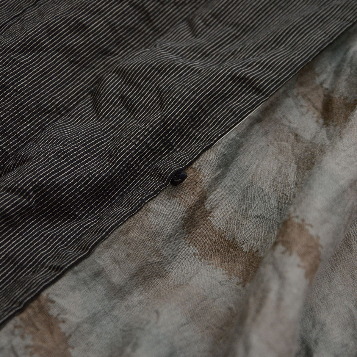 Haori tie attachment loop beside fine-striped fabric and patterned cotton lining