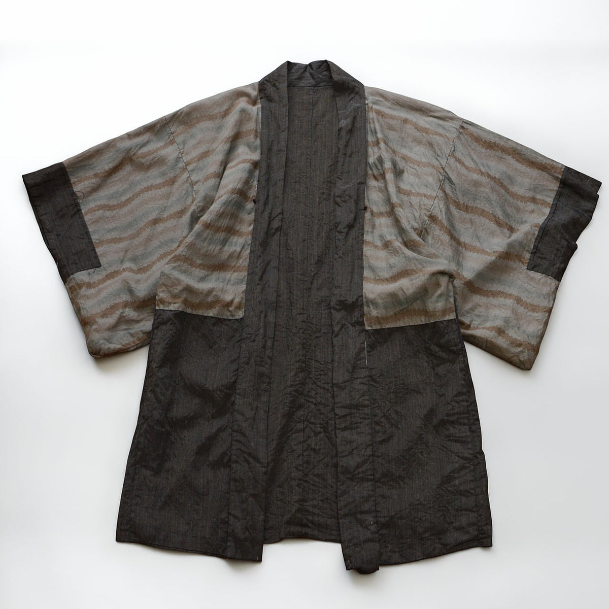 Muted patterned cotton lining and dark striped sections of a long vintage haori