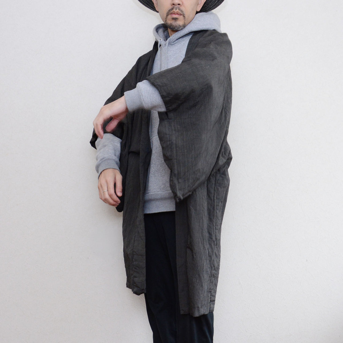 Generous haori sleeve with a grey hoodie sleeve and dark trousers