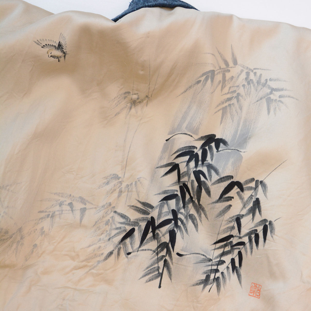 Haori jacket interior lining, bamboo grove motif in black ink on beige ground