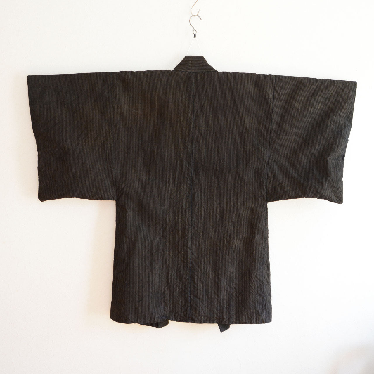 Indigo striped haori jacket styled over modern casual clothing