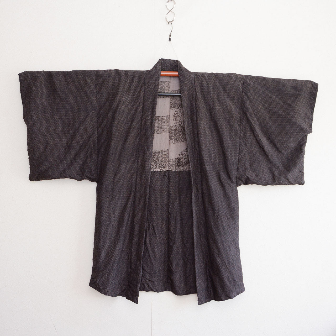 Vintage haori jacket, front view, on kimono hanger, komon pattern, dark silk blend, wide sleeve silhouette, Japan 1970s–80s