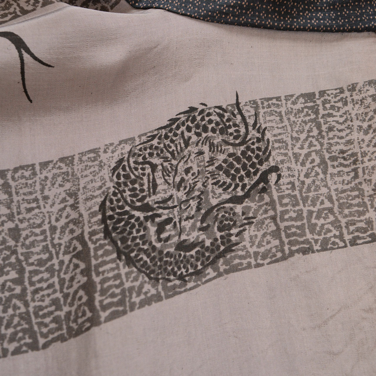 Dragon lining of vintage haori jacket, bold dragon motif with clouds and waves, printed on beige fabric, Japan vintage