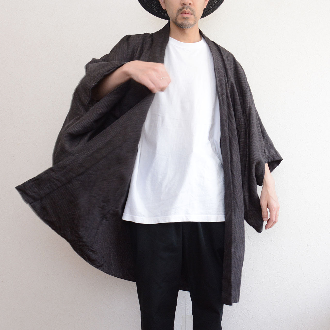 Male model wearing vintage haori jacket, front view in motion, komon pattern, dark silk blend, wide sleeve movement, Japan vintage streetwear